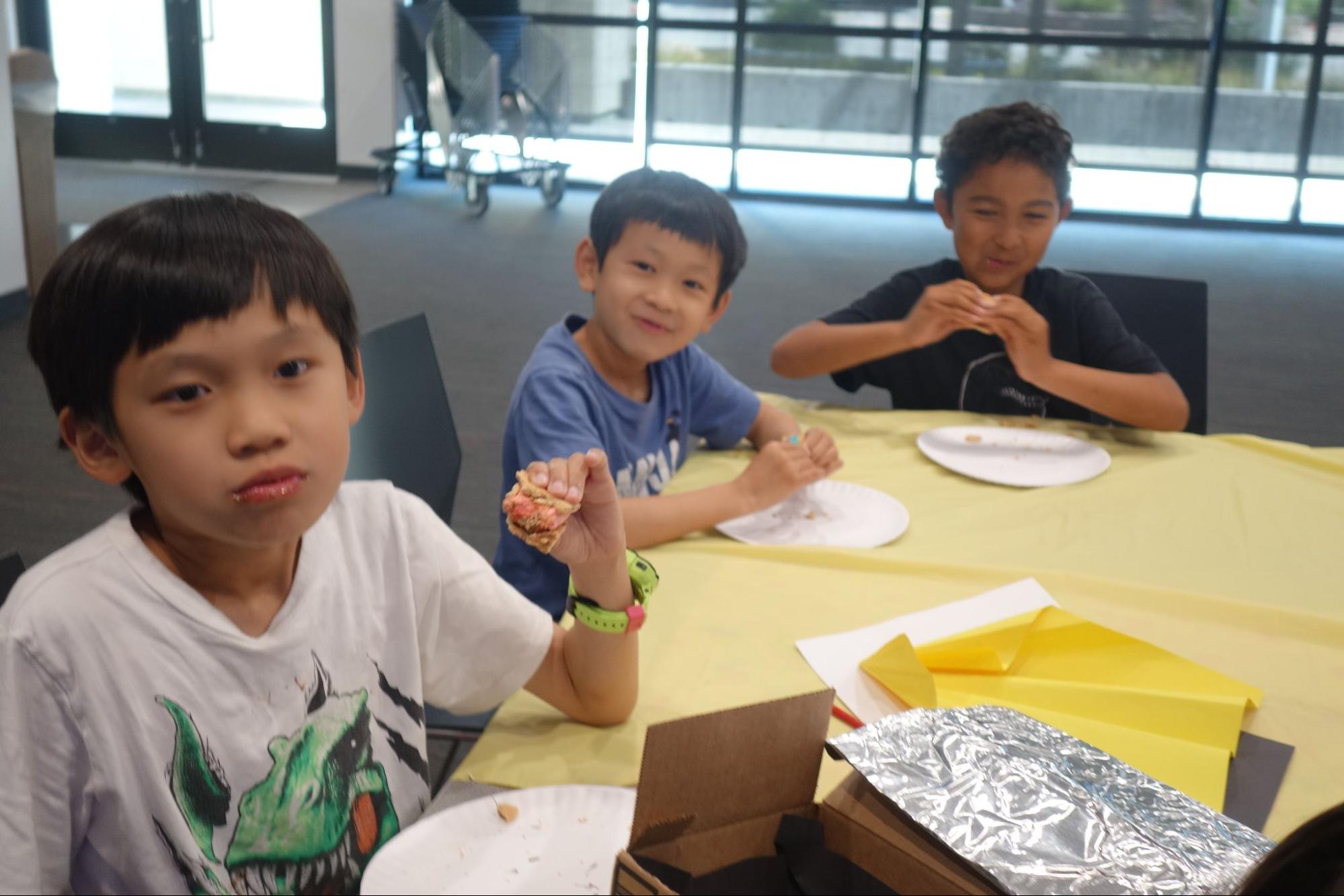 Students eat smores after baking them in the solar oven